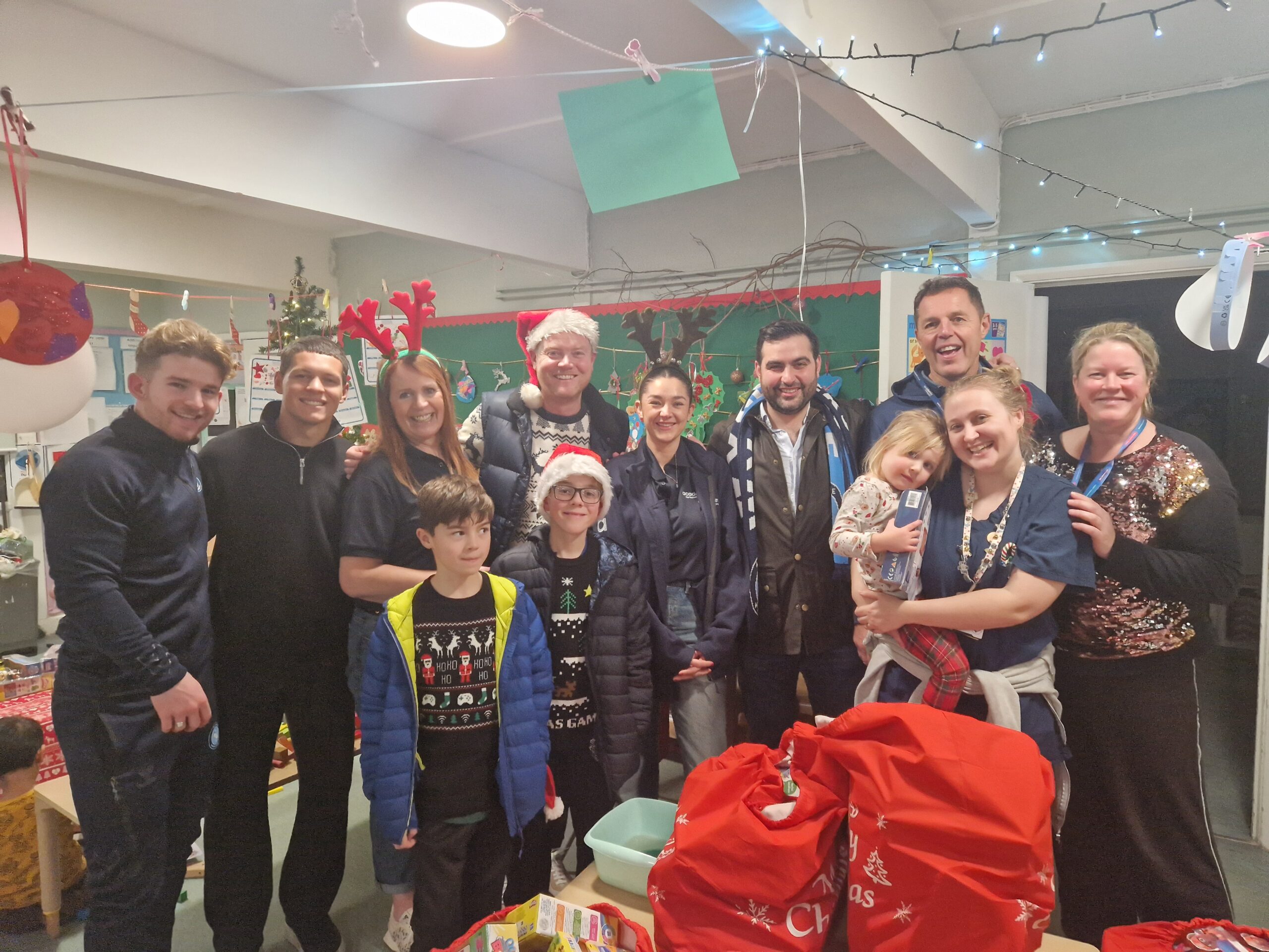 Andrew Harman, Tjay De Barr, Jasper Pattenden along with a nurse and their child during the visit to the staff creche in Wycombe.